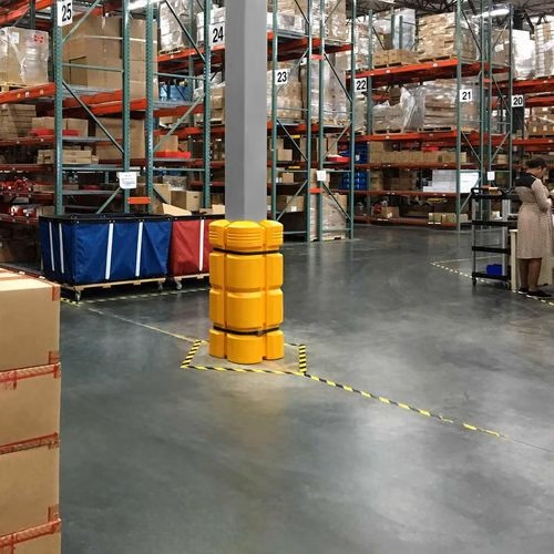 Column guard around a column in a storage facility with racking in the background